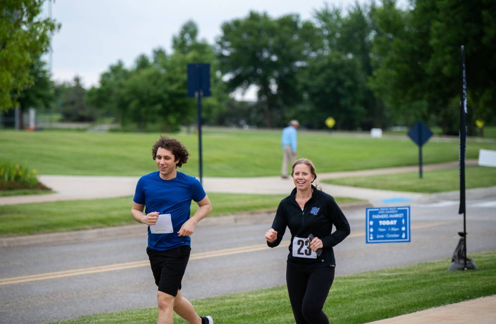 Cameron Jones and Michele Heibel running together and smiling